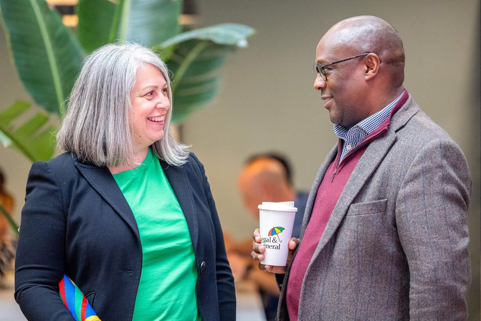 executive leadership smiling and having a conversation 